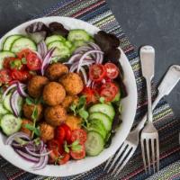 Falafel Salad · Mouthwatering Falafel Salad with tomatoes, green peppers, cucumbers, lettuce, parsley and sp...