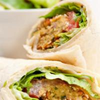 Falafel Wrap · Mouthwatering wrap with three pieces of falafel, cucumbers, tomatoes, and tahini sauce. Serv...