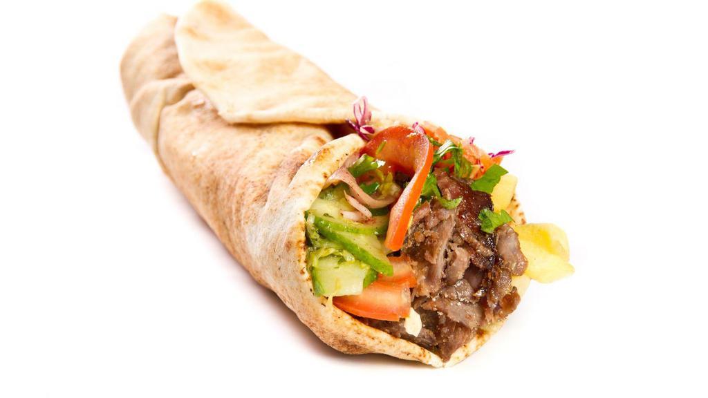 Kofta Kebab Wrap · Two skewers of kofta kebab, tomatoes, onions and tahini sauce wrapped together perfectly.