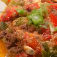 Baked Furghessa On Clay · Mixture of green peppers, tomatoes, ricotta cheese, and beef with spices, served with potato...