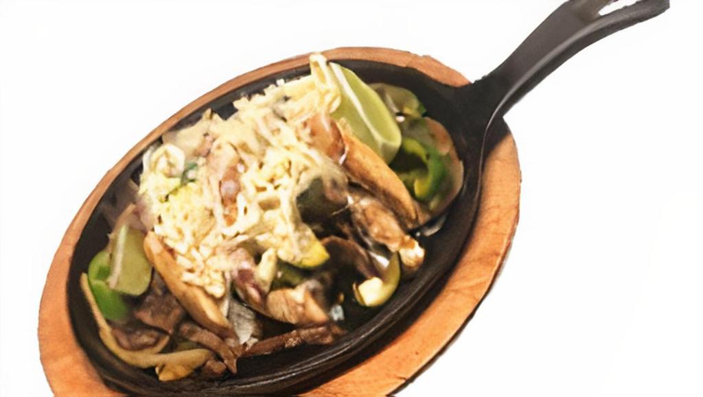 Tex Mex Fajita · Steak, and Chicken, with grilled bell peppers, 
onions, tomatoes, zucchini. mozzarella cheese. On top. Side: rice, beans, lettuce, pico de gallo, sour cream, and 
guacamole sauce. Choice of tortillas: flour or corn.