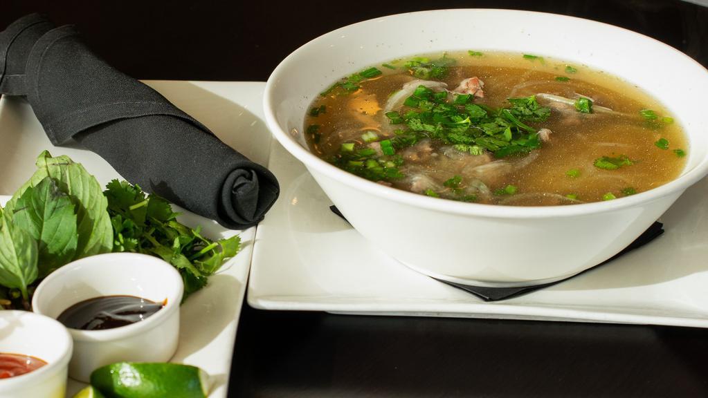 Pho · Thinly sliced steak and Vietnamese noodles in rich beef broth. Bean sprout, basil, cilantro, and lime garnish.