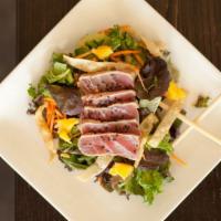 Seared Ahi Tuna Salad · Served over mixed greens with carrot,  jicama, orange, honey glazed almonds, and crispy wont...
