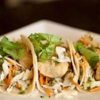 Fish Tacos · Crispy cod with Asian slaw. Served in corn tortillas.
