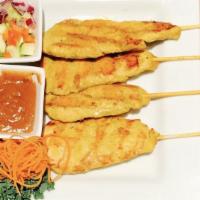 Chicken Satay · Grilled marinated chicken served on skewers with peanut sauce and a cucumber salad.