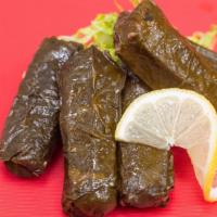 Veggie Grape Leaves · Cooked grape leaves stuffed with parsley, tomatoes, rice and lemon juice.
