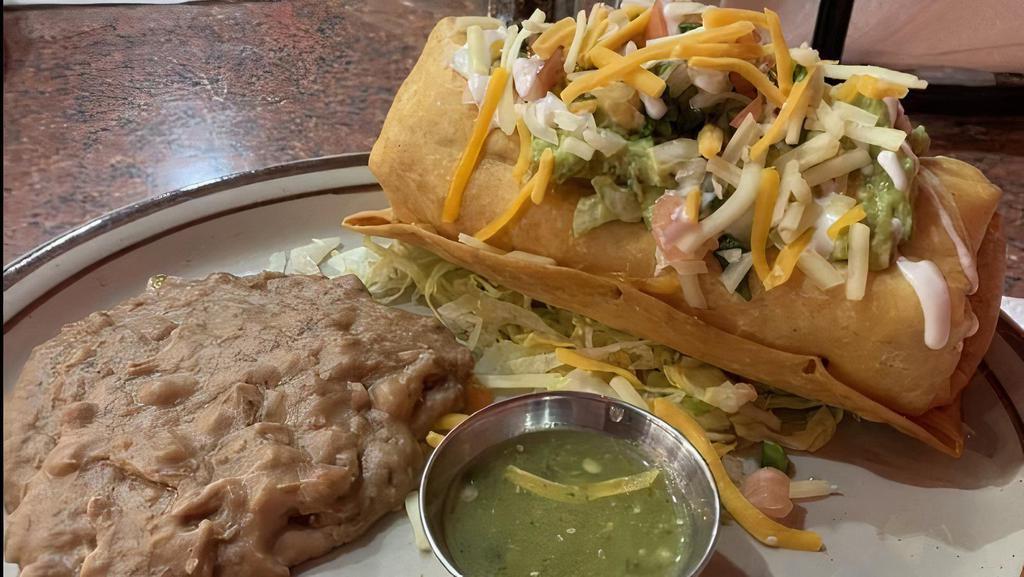 Chimichanga · Rice, Mexican blend cheese, your choice of meat, wrapped in flour tortilla. Topped with guacamole, pico de gallo, sour cream cheese and side of refried or black beans.