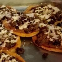 3 Sopes · Gluten Free. Served with refried beans, topped with sour cream, cheese, lettuce and salsa on...
