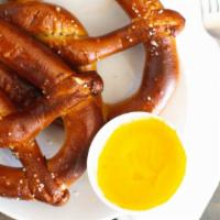 Giant Pub Pretzel · Warmed in the oven and served with homemade caballero cheese sauce.