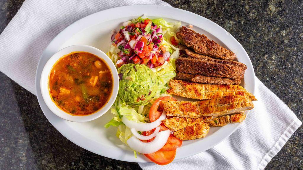 Ranchero · Grilled chicken and steak, served with lettuce, onions, tomatoes, guacamole, pico de gallo and charro beans.