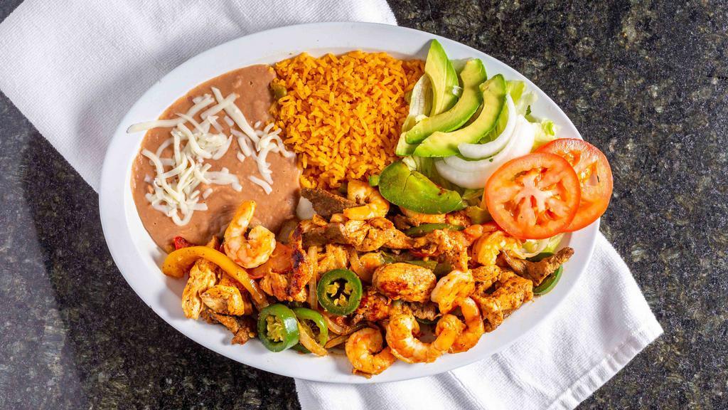 Plato Con Camarones · Sautéed steak, chicken and shrimp with tomatoes, bell pepper, onions and jalapeños, served with lettuce, tomatoes, onions, avocado, rice and refried beans.