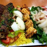 Afandina Mix Grill · Chicken kebab, shish kebab, kofta, rice, and salad.