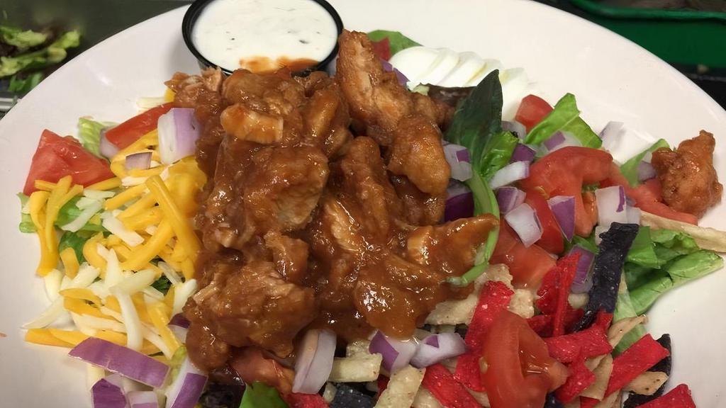 Bbq Chicken Tender Salad · Mixed greens, fried chicken tenderloins in our house made BBQ sauce, boiled eggs, cheddar jack cheese, tomato, red onion, tortilla strips, served with ranch.