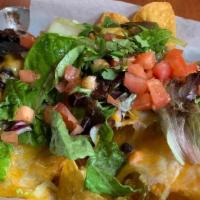 Loaded Nachos · tortilla chips loaded with . cheese, black beans, lettuce, tomato, salsa, red