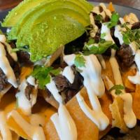 Dave'S Loaded Nachos · Homemade tortilla chips topped with choice of protein, sour cream, queso sauce, avocado and ...