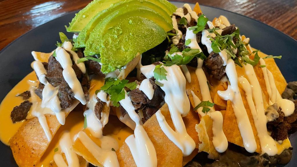 Dave'S Loaded Nachos · Homemade tortilla chips topped with choice of protein, sour cream, queso sauce, avocado and cilantro
