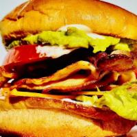 Backyard Turkey Club · Turkey and bacon set on a brioche bun topped with guacamole, cheddar cheese, lettuce, tomato...