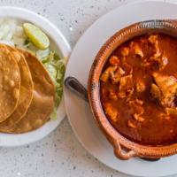 Pozole Con Patita · A traidtional mexican stew made with hominy meat and vegetables.