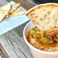 Hummus · Creamy chickpea, sesame tahini, garlic and spices with olive oil and served with grilled pit...