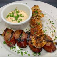 Shrimp & Sausage Skewers · two skewers with grilled seasoned shrimp and sausage with a side of remoulade sauce