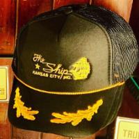 Embroidered Skipper'S Cap · black mesh-backed trucker's cap in black, embroidered with The Ship logo in gold along with ...