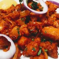 +Chicken Manchurian · ...stir fried boneless chicken thighs with onion, peppers, scallions in manchurian sauce