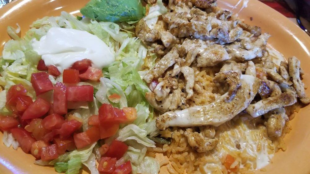 Chori Pollo · Grilled chicken breast with chorizo, topped with cheese sauce, served with rice and beans.