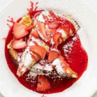 Atlantic City - Stuffed French Toast · Brioche toast stuffed with cinnamon cream cheese and topped with strawberries, strawberry sa...