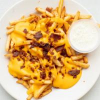 Loaded Fries · Ale battered fries topped with cheddar cheese sauce and bacon. Served with Ranch.