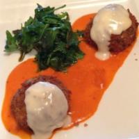 Louisiana Crab Cakes (2) · Real crab meat, pan sautéed, served with roasted pepper cream sauce, and garnished with arug...