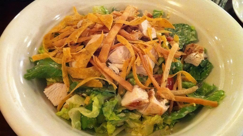 Santa Fe Salad · Gluten free. Charbroiled chicken breast, roasted com, black beans, Monterey cheese, tortilla strips, tomatoes, peppers, and romaine lettuce with homemade.