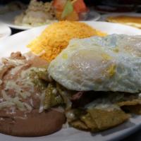 Chilaquiles Verde · Tortilla chips smothered with cheese, homemade green sauce, chopped onions and topped with 2...