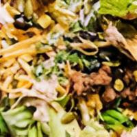 Taco Salad · A bed of lettuce served with choice of protein, beans or veggies, and toppings.