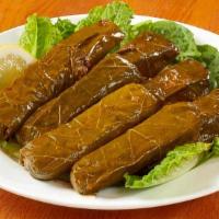 Vegetarian Grape Leaves · Grape leaves stuffed with tomato, onion, parsley, rice and spices; cooked with lemon, vegeta...