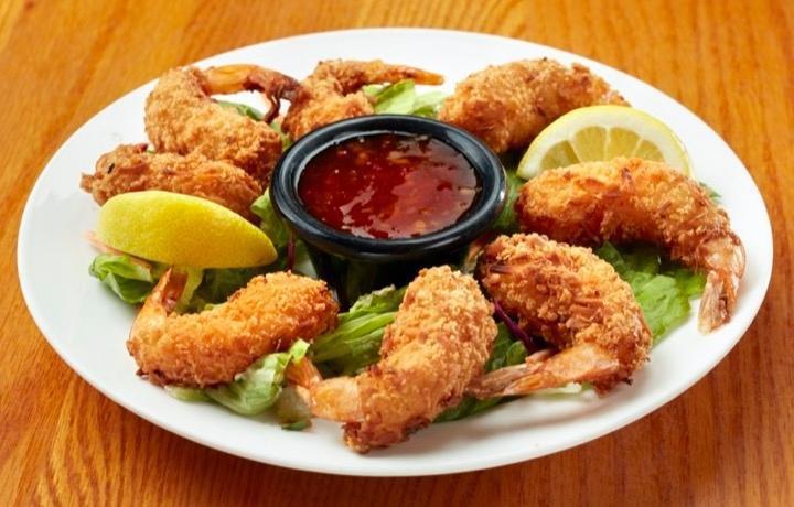 Mediterranean Coconut Shrimp · Hand-dipped in our signature batter, then tossed in coconut and fried golden brown, served with our signature sauce.