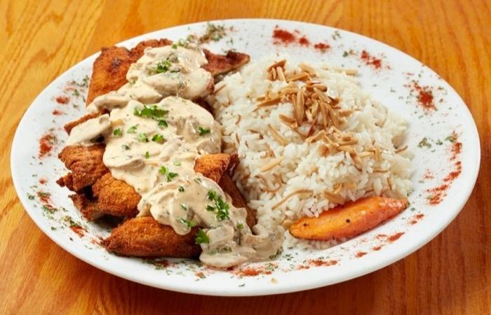 Chicken Cream Chops · Tender chicken, seasoned and breaded, pan-fried to a golden brown, served with our signature garlic cream of mushroom sauce.