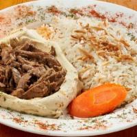 Hummus With Lamb Shwarma · Marinated layers of lamb, flame cooked and cut into small bite size pieces served on top of ...