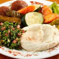 Vegetarian Deluxe · Two pieces of falafel, two pieces of vegetarian grape leaves, signature hommus and tabulee.