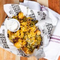 Loaded Tots · Crispy Tater Tots, Shredded Wisconsin Cheddar, Bacon, Jalapeño & Sour Cream Drizzle Add Gril...