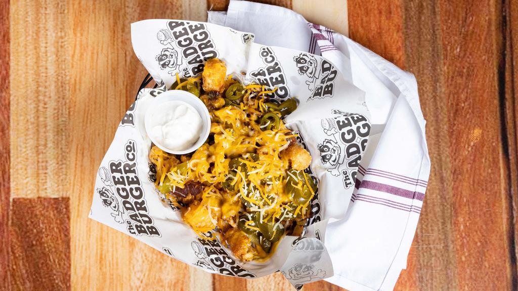 Loaded Tots · Crispy Tater Tots, Shredded Wisconsin Cheddar, Bacon, Jalapeño & Sour Cream Drizzle Add Grilled Chicken for an additional charge.