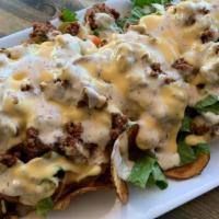 Captain Joe'S Nachos · Gluten-free. Fresh cut potato chips smothered with creamy gouda and cheddar cheese sauce, le...