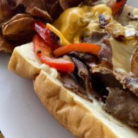 Philly Cheesesteak · Thin sliced steak, seared with sautéed onions, bell peppers, and smothered with swiss and Am...