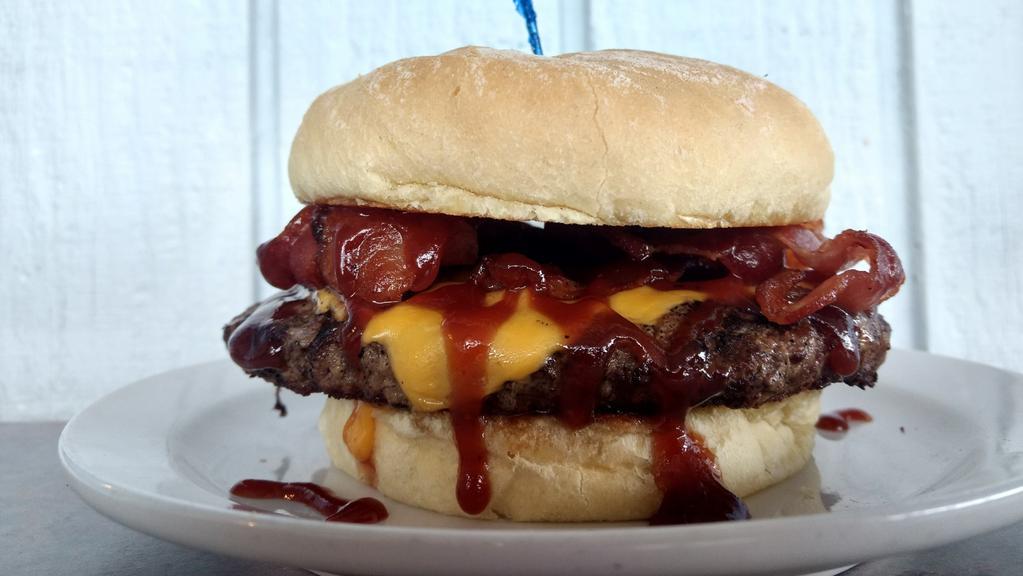 Pub Burger · Char-grilled burger layered with American cheese, bacon and BBQ sauce.