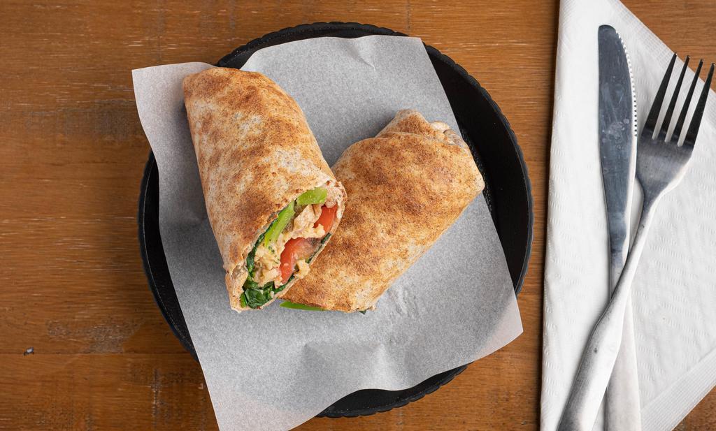Buddha · Seek enlightenment in your jovial potbelly with this veggie wrap. Spring greens, green peppers, tomatoes, veggie crumbles, spinach, and cheese (dairy or vegan). With your choice of sauce.