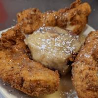 Chicken Bread Pudding · Our house-made bread pudding topped with three dredged and fried chicken tenders and powdere...