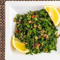 Tabouli Salad · Chopped parsley, tomato, and onions with fine cracked wheat tossed in lemon and olive oil.