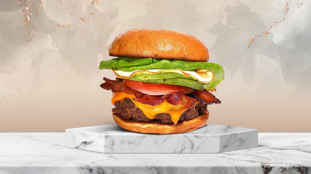 Morning Mystery Burger  · American beef patty topped with bacon, fried egg, avocado, melted cheese, lettuce, tomato, onion, and pickles. Served on a toasted bun.