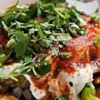 Papadi Chat · Chickpeas, minced potatoes, crispy fritters, and yoghurt sprinkled with a dash of black Indi...