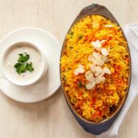 Vegetable Biryani · Long-grain basmati rice layered with fresh vegetables, toasted nuts and plump raisins, steam...