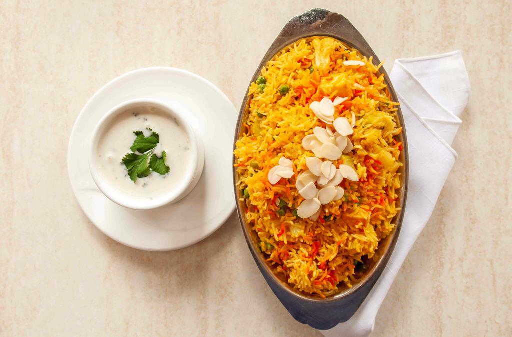 Vegetable Biryani · Long-grain basmati rice layered with fresh vegetables, toasted nuts and plump raisins, steam-cooked with aromatic spices.